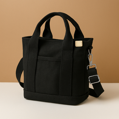 Canvas shoulder bag with multiple compartments for women.