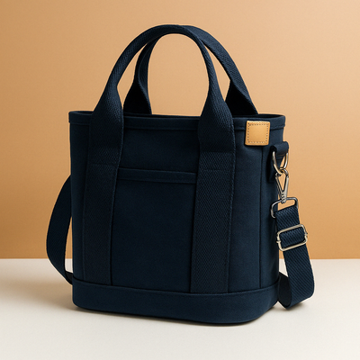 Canvas shoulder bag with multiple compartments for women.